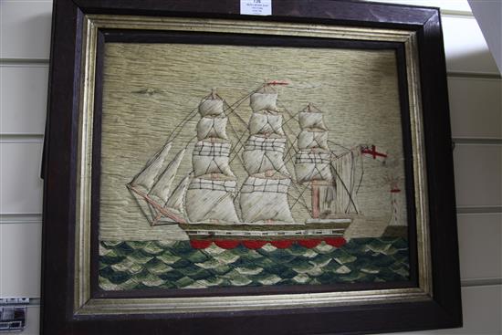 A Victorian woolwork ship picture depicting a frigate and lighthouse, 12.5 x 15.5in.
